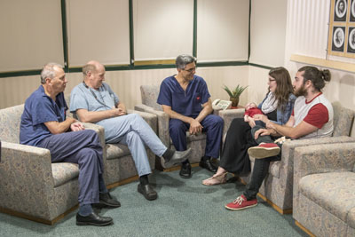 A group of people sit together in conversation.
