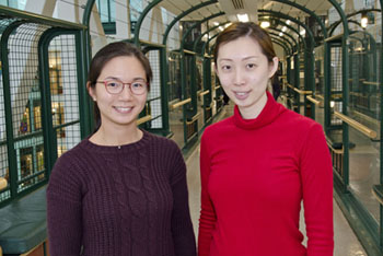 Two women stand side by side.