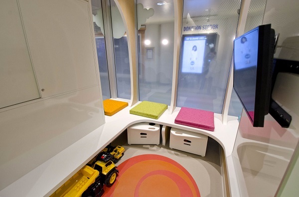 Gaming corner with a bench seat and mounted television.