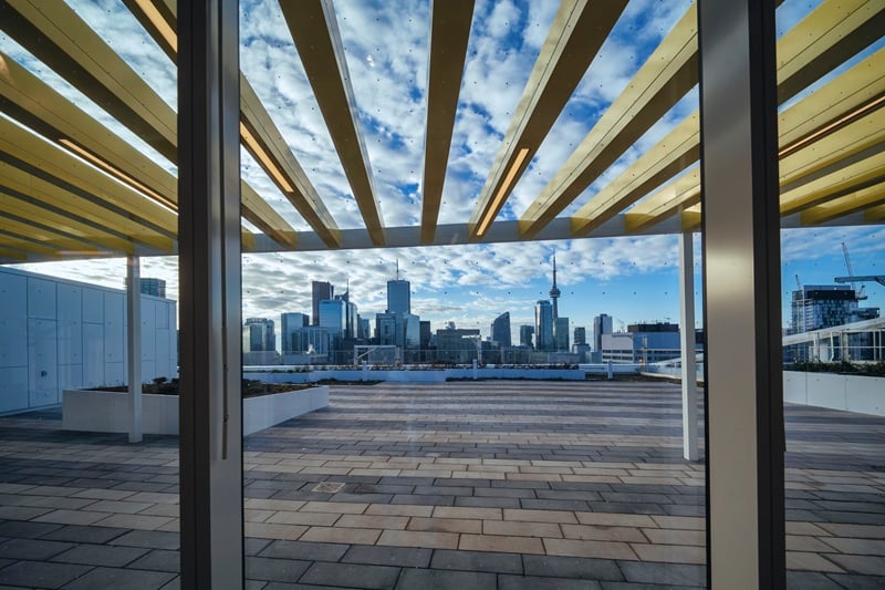 A view of a rooftop deck with the CN tower in the background.