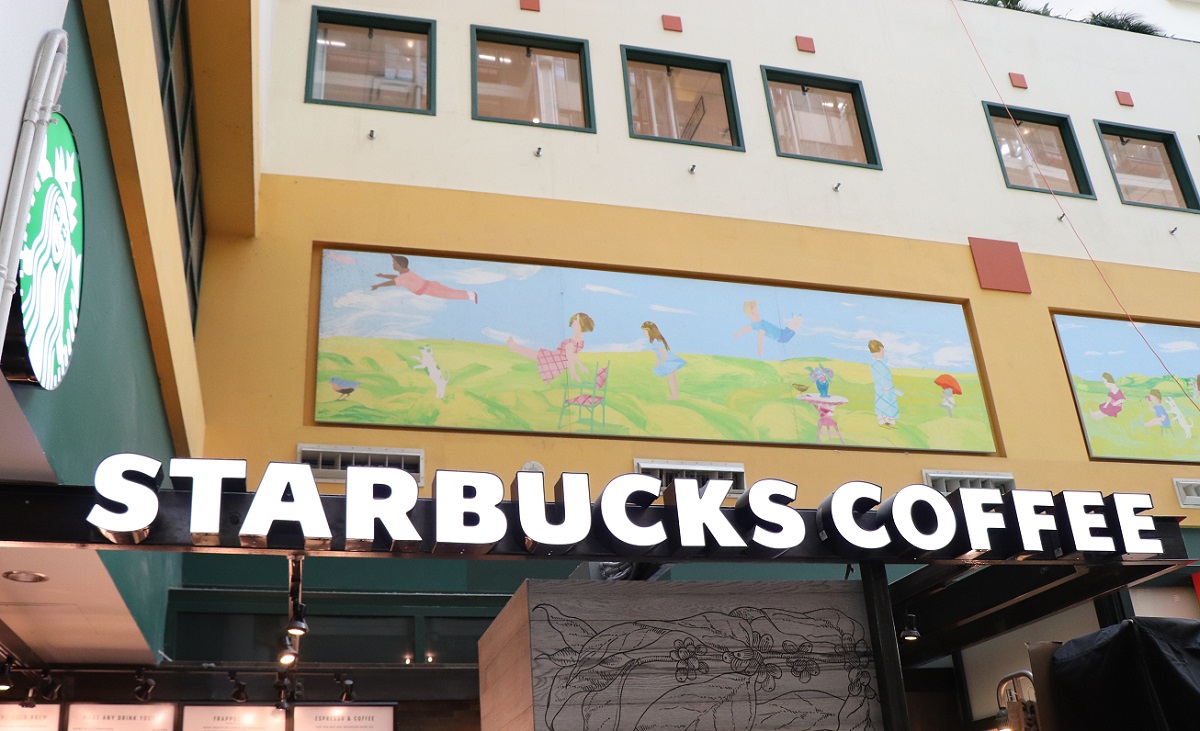 Starbucks signage displayed on a wall.
