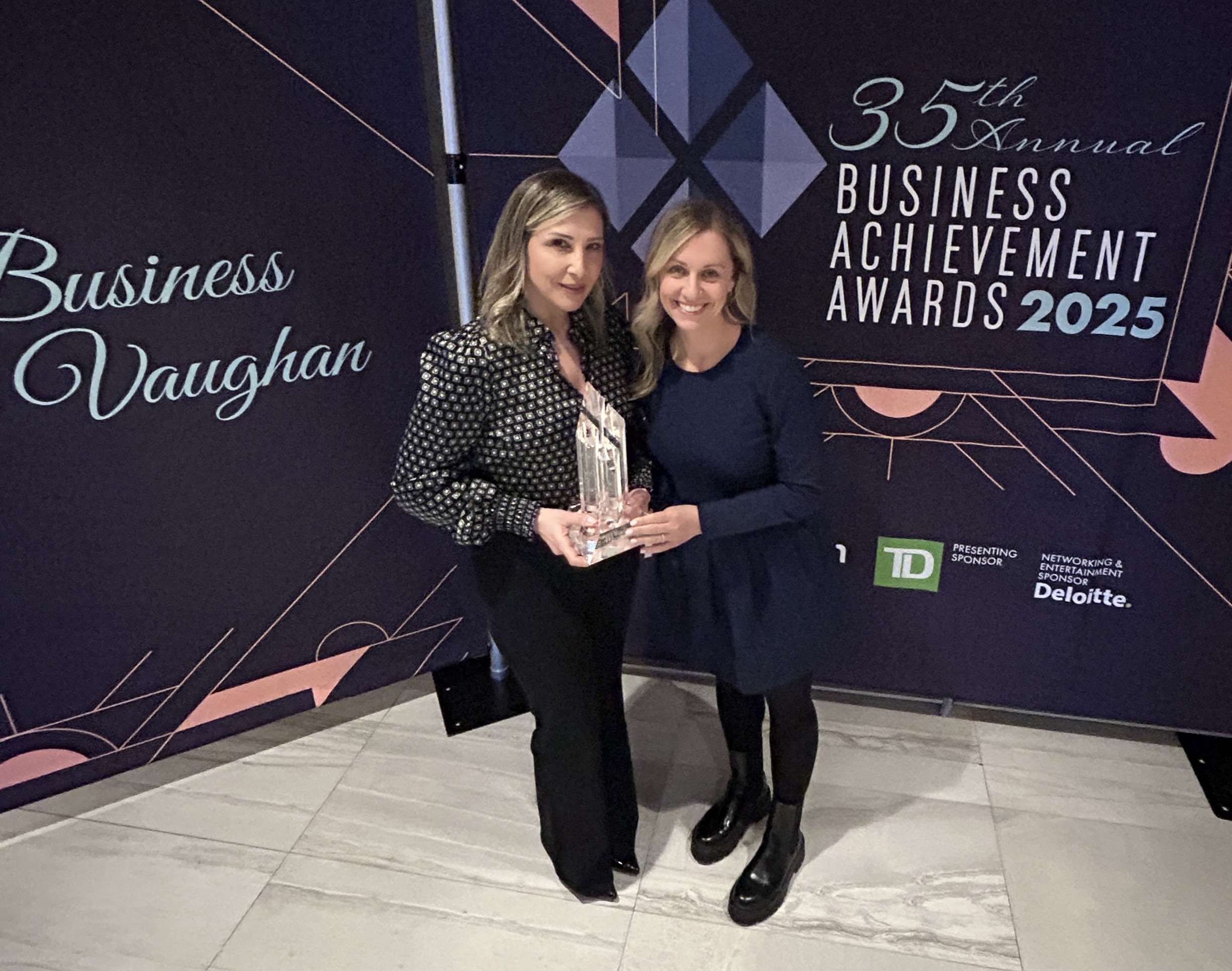 Lara Pietrolungo and Julia Orkin holding an award.