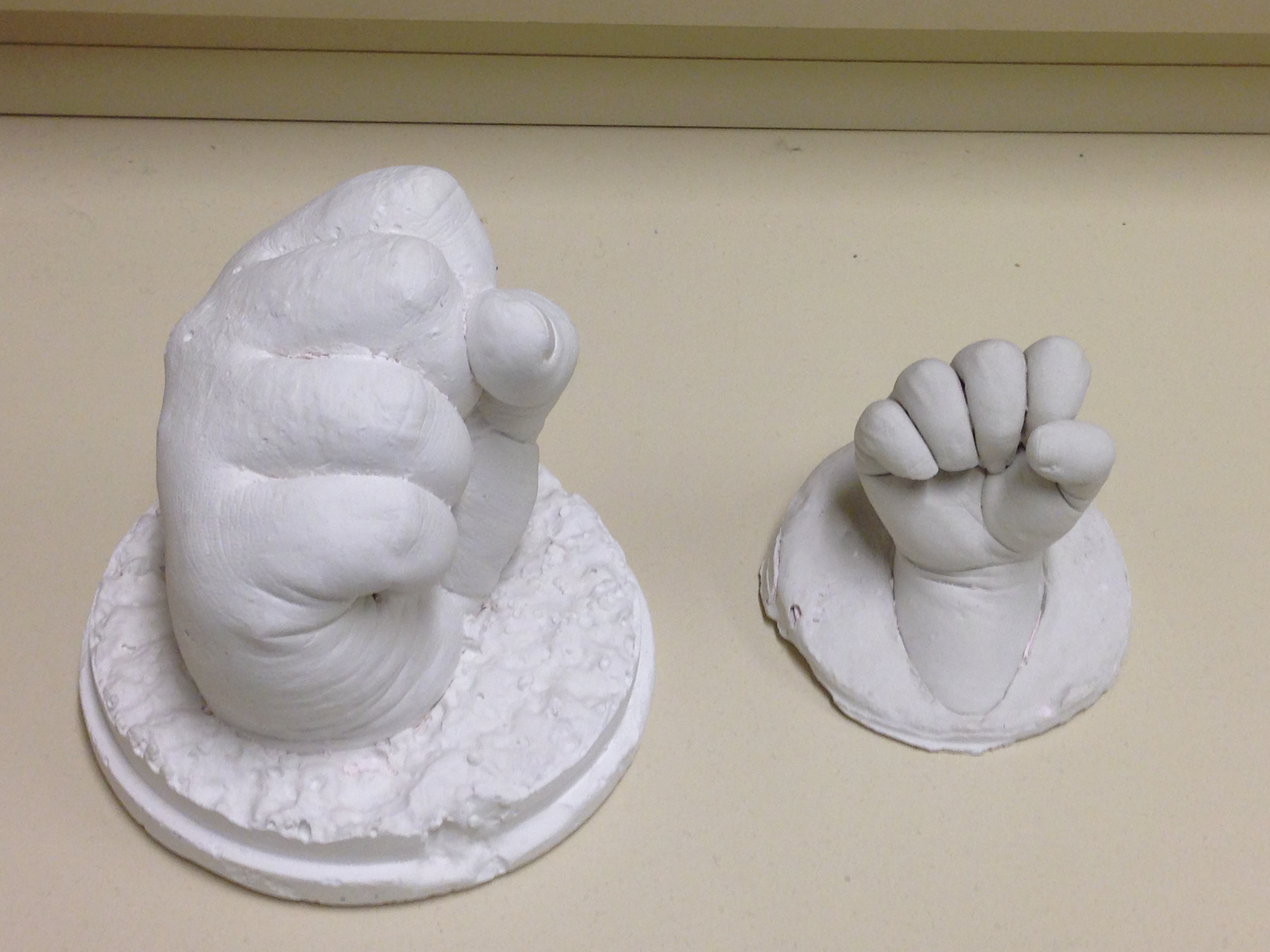 Legacy clay mold of a big hand and a small hand