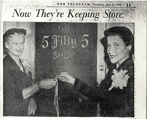 Scan of old newspaper. Two women wearing hats and flower corsages stand in front of the 5Fifty5 Shop sign.