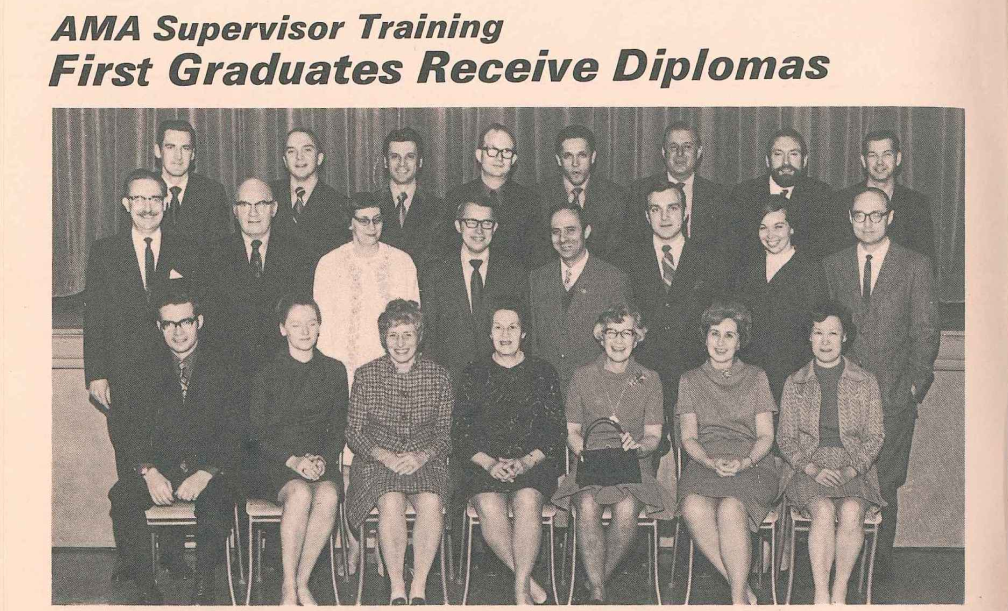 Black and white newspaper or magazine clipping titled "AMA Supervisor Training First Graduates Receive Diplomas" showing a formal group photo of graduates arranged in three rows. Women sit in front row while men stand behind, with all participants named in caption below the image.