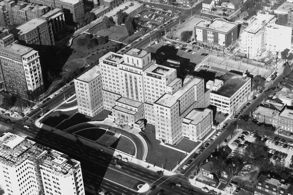 Vintage black and white aerial photograph of large hospital complex with multiple buildings surrounded by urban neighborhood.