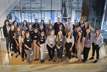 Group of approximately 30 people pose for a group photo. All are wearing business casual attire.