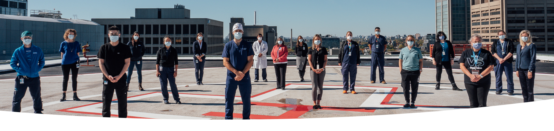 SickKids hospital workers standing on top of the emergency helicopter pad.