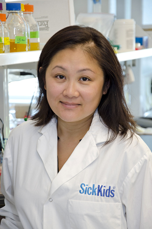 Scientist wearing a lab coat in a lab setting.