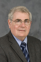 Headshot of man wearing glasses.