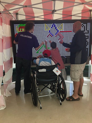 People create a Canada flag with lite brite (small lightbulbs on a board).