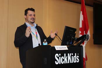 Person stands behind a podium.