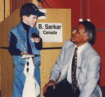 Man crouches next to patient.