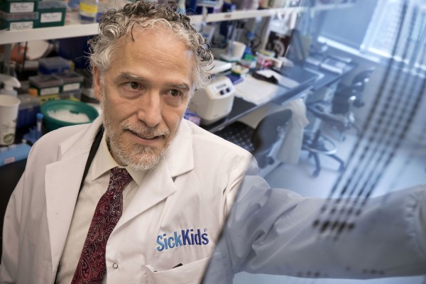 Christopher Pearson hold up a DNA scan in the lab