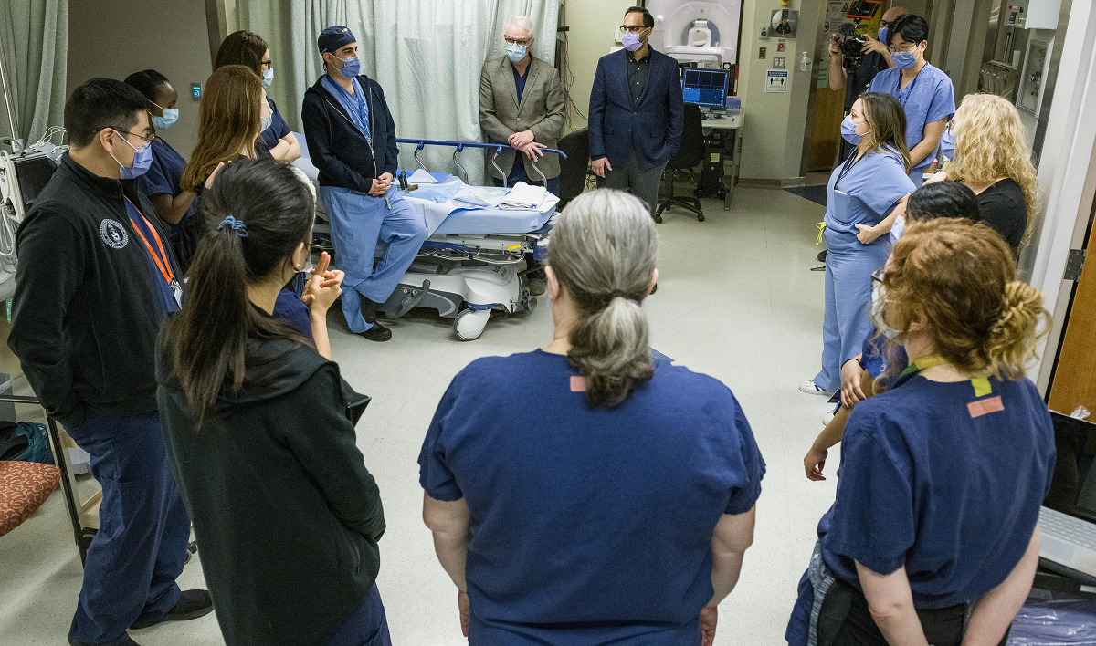 Team huddle in hospital room.