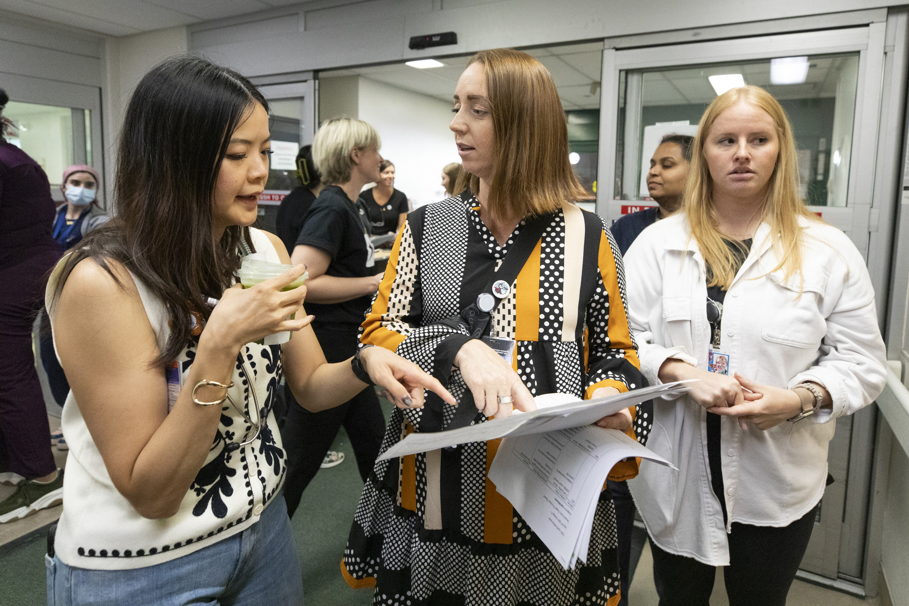 Charge nurse Leah McFeeters, centre, speaks to another staff member in front of the ambulance bay before the simulation begins. 