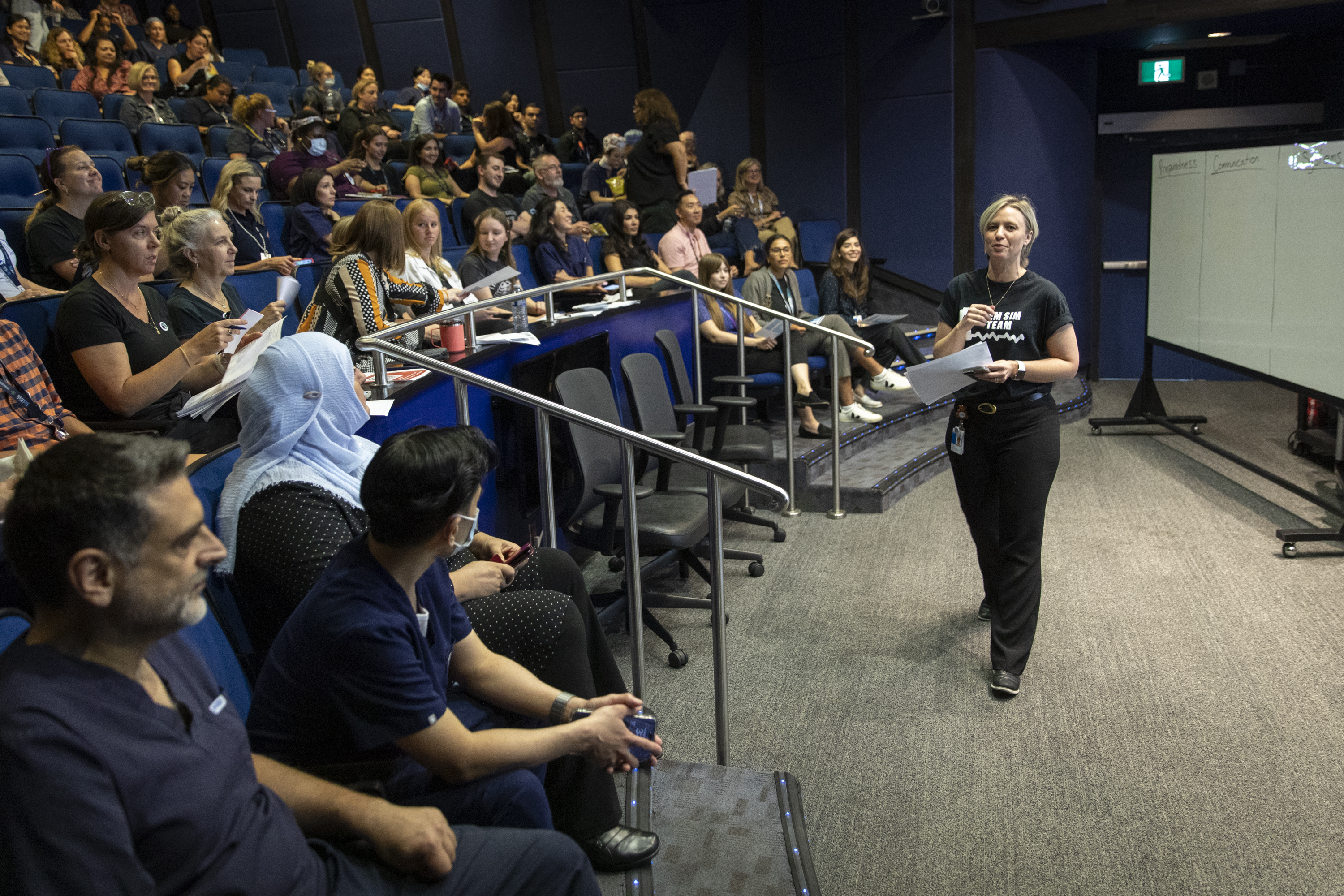 Interprofessional Education Specialist and nurse Seona Dunbar addresses a crowd of participants and facilitators