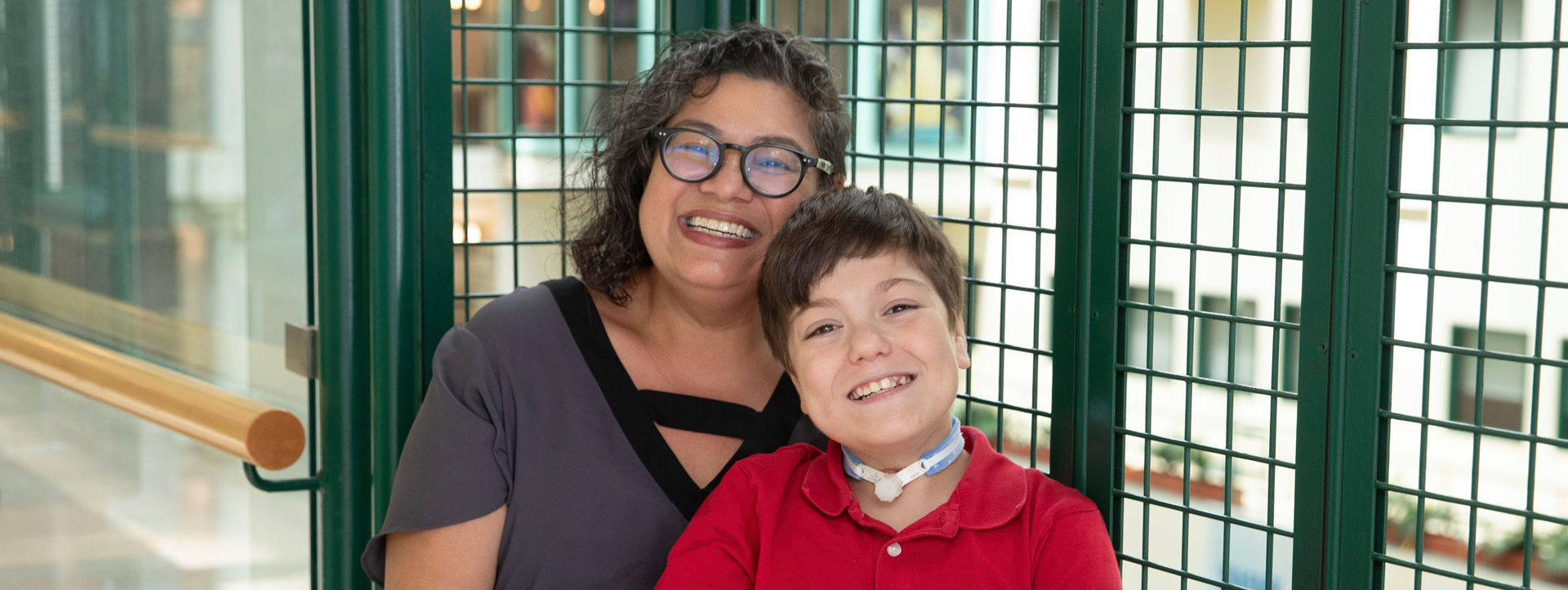Francine Buchanan and her son, Cristiano, posing together for a photo overlooking the Atrium.