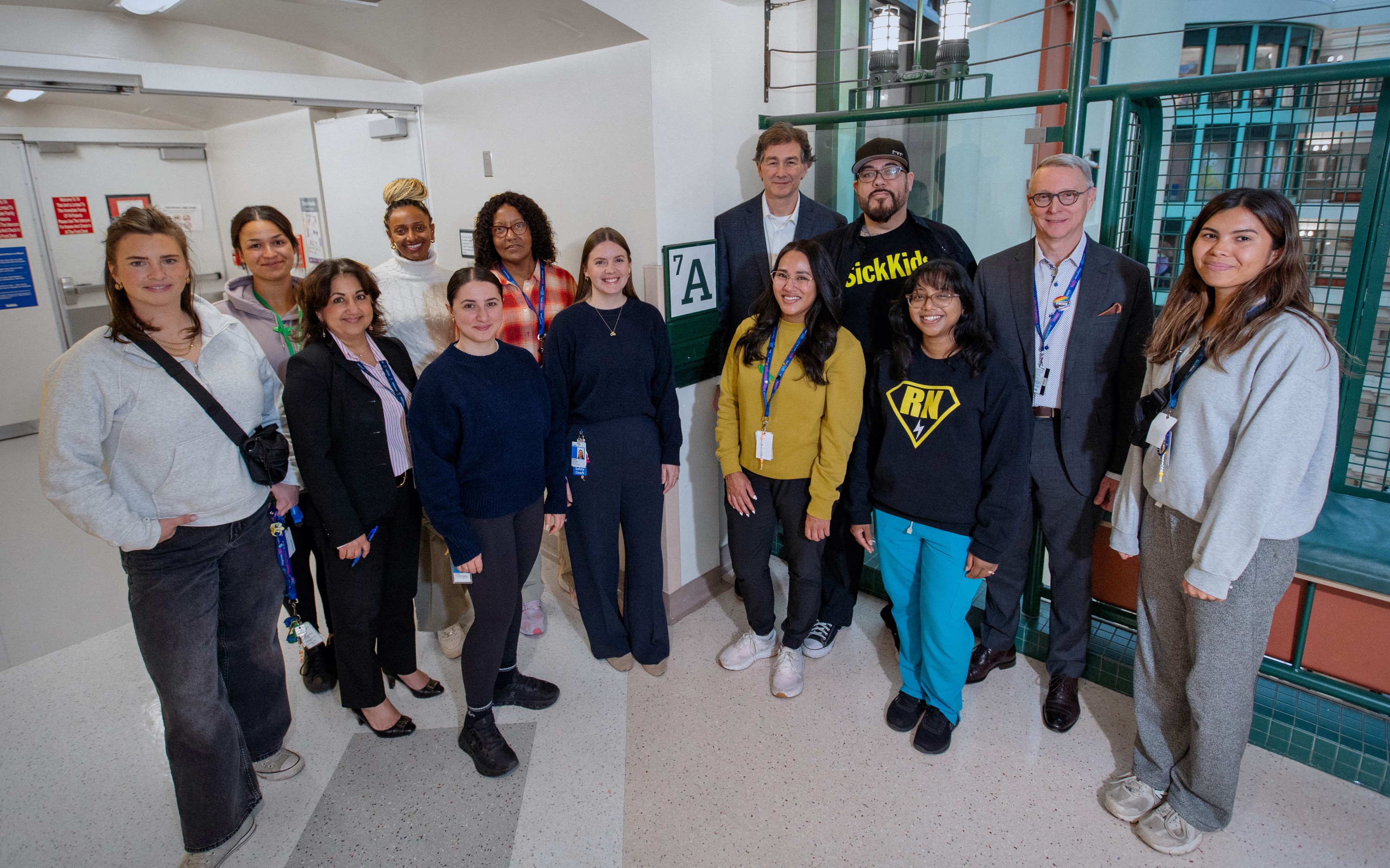 Members of SickKids' mental health leadership and front-line staff gather in the hospital in celebration of the Schedule 1 designation.