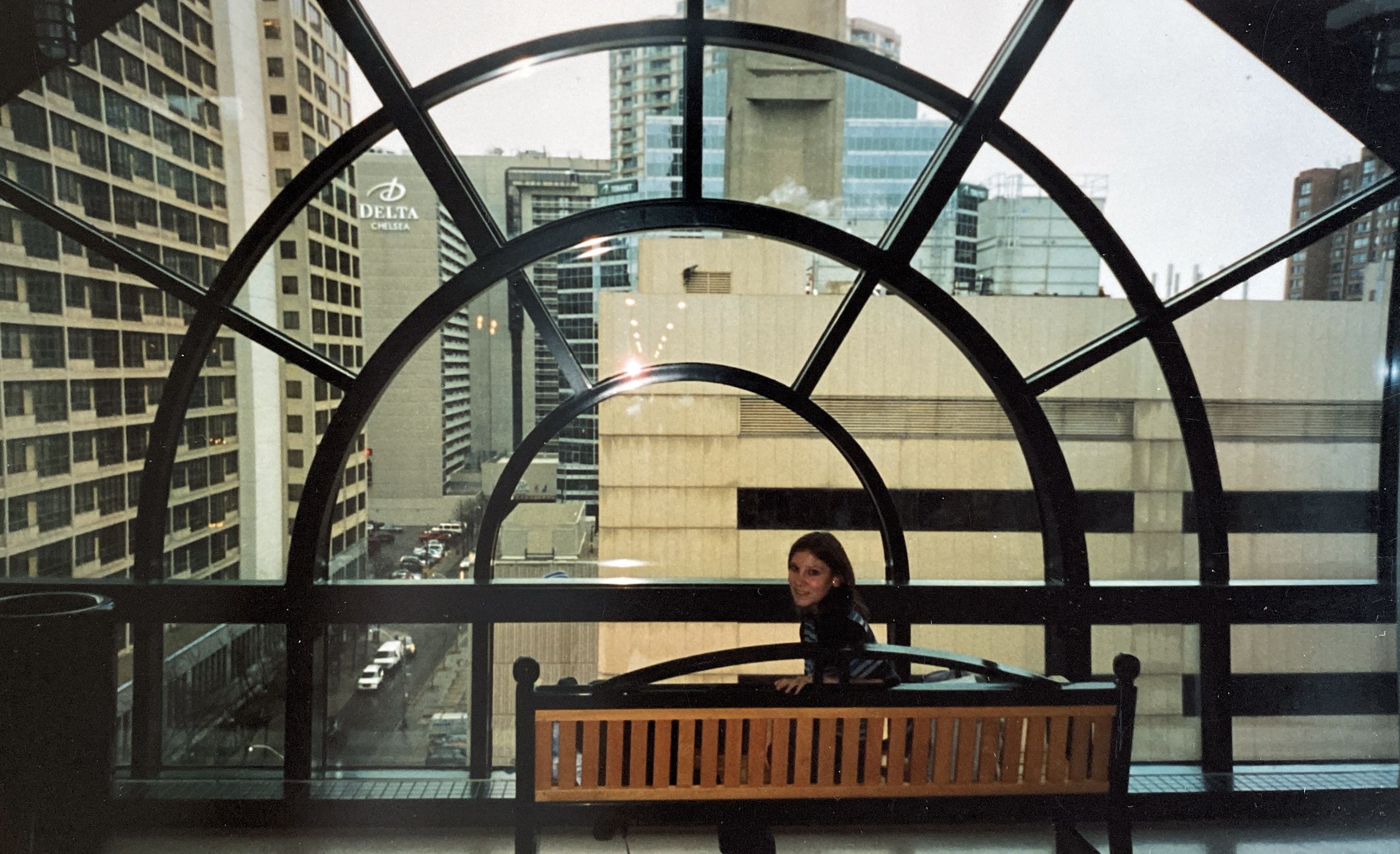 Natalie, age 17, sitting on the same bench on the eighth floor.