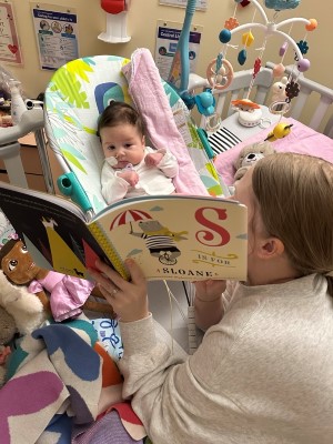 Sloane's mom Stephanie reads her a book called S Is For Sloane. 