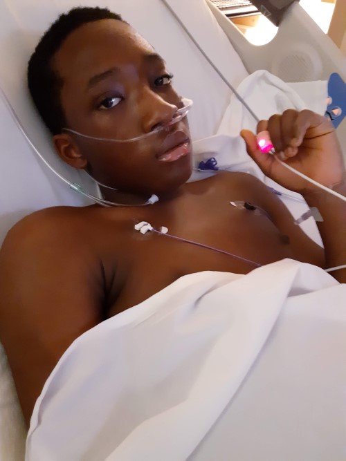 A close-up on James's face in a hospital bed with a white blanket.