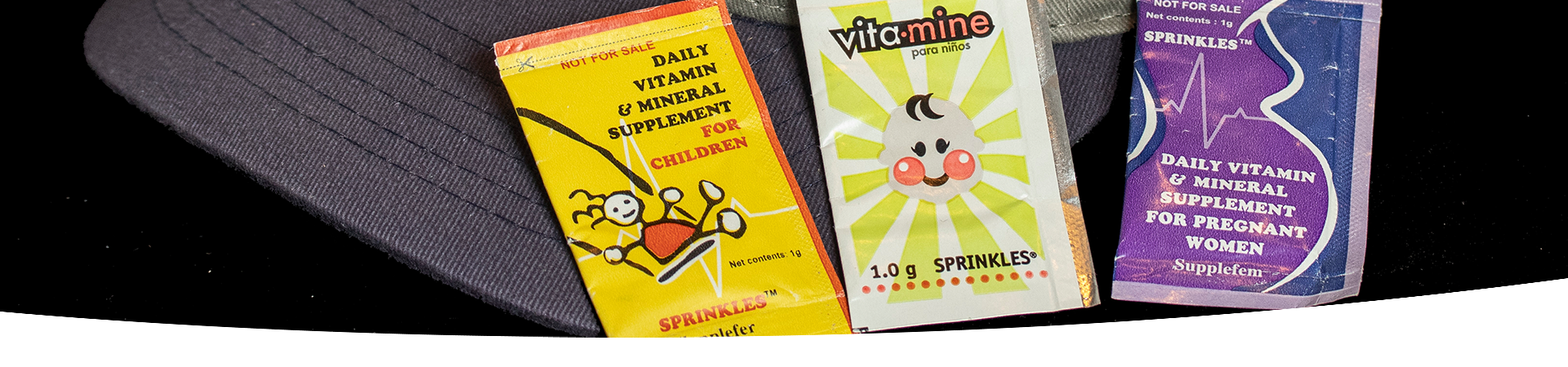 A close-up of three packets of Sprinkles. 