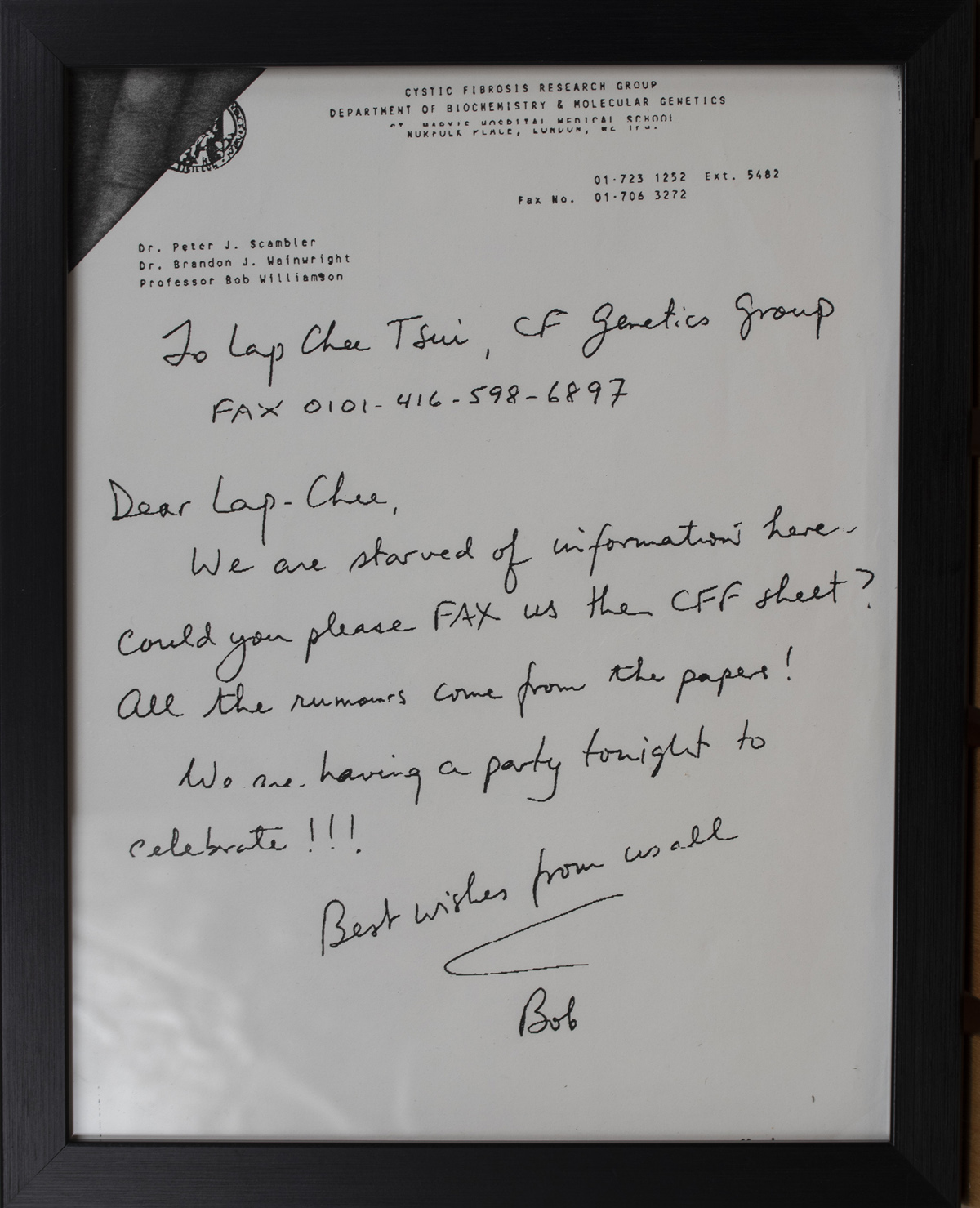 Framed faxed letter from a cystic fibrosis research group congratulating a colleague and requesting information following a scientific breakthrough.